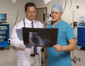 bigstock doctor and surgeon reviewing x 827515